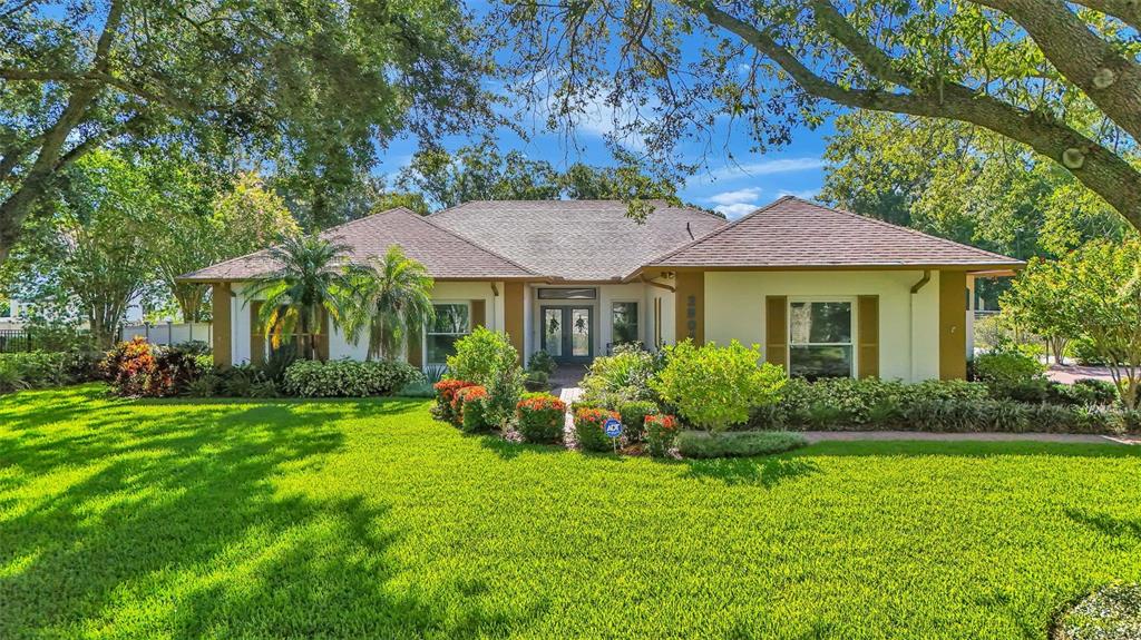 a view of a house with garden and yard