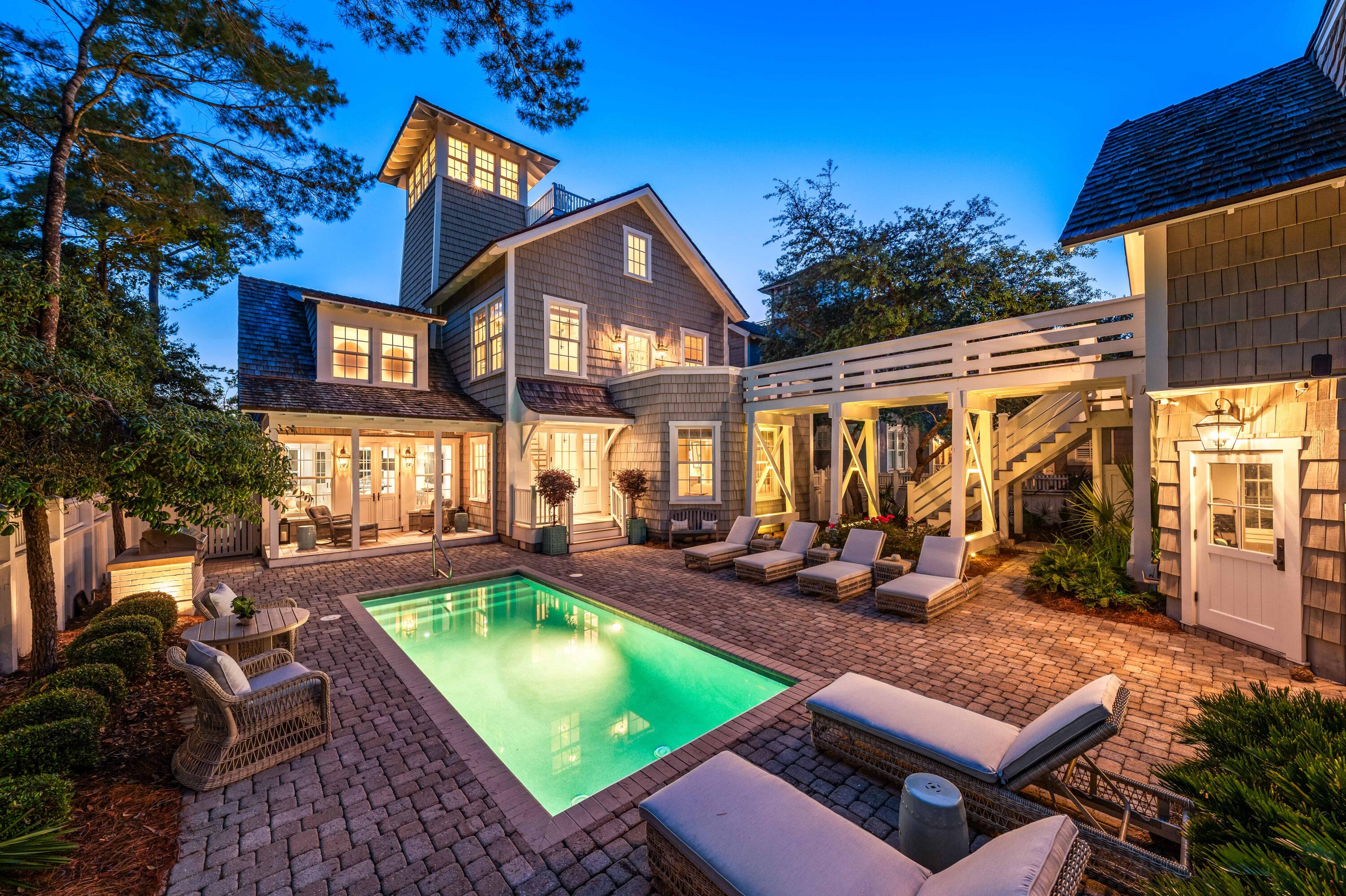 a view of a house with swimming pool and sitting area