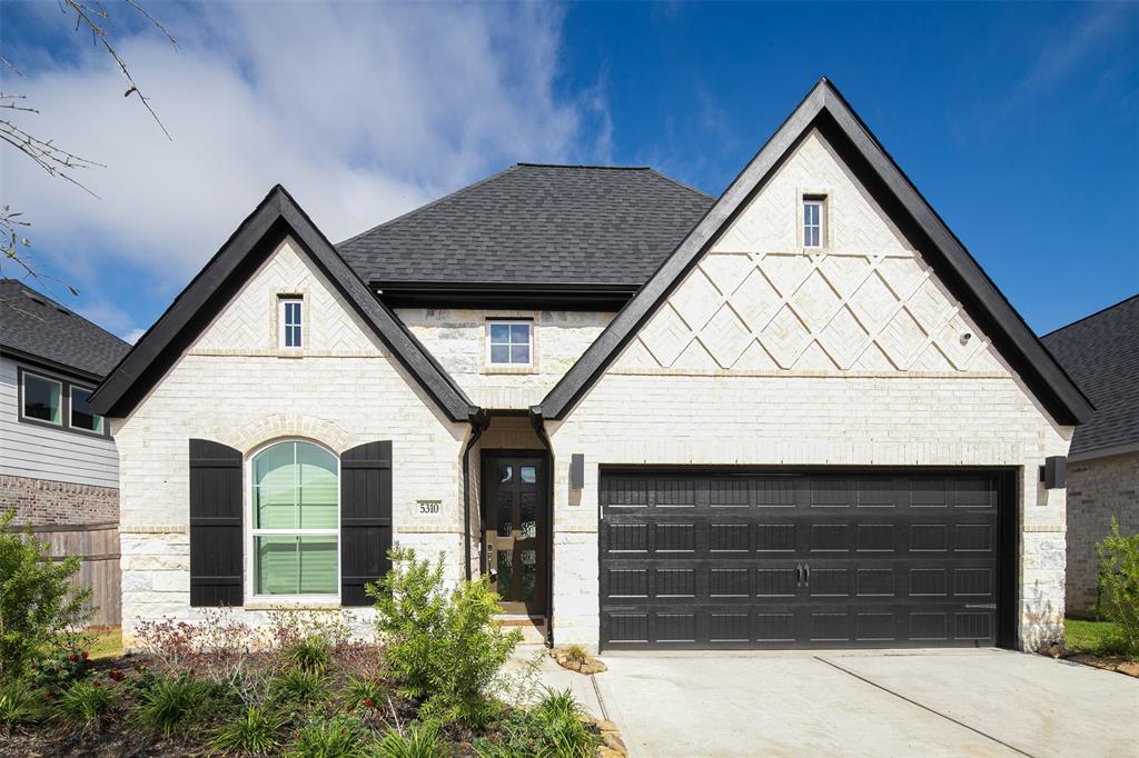 a front view of a house with garage