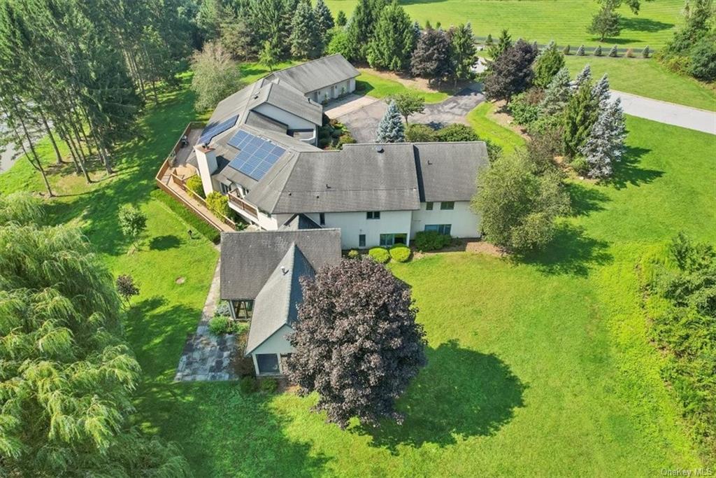 an aerial view of a house with a yard basket ball court and outdoor seating