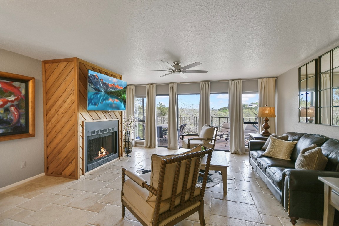 a living room with furniture a flat screen tv and a fireplace