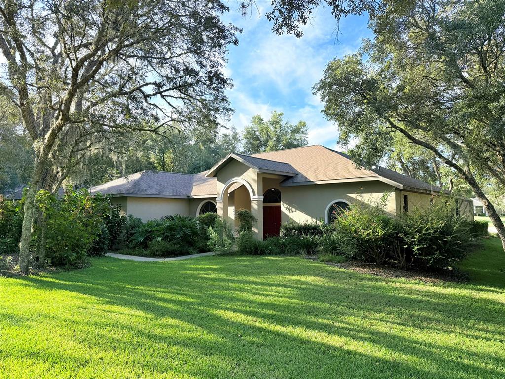 a front view of house with yard and green space