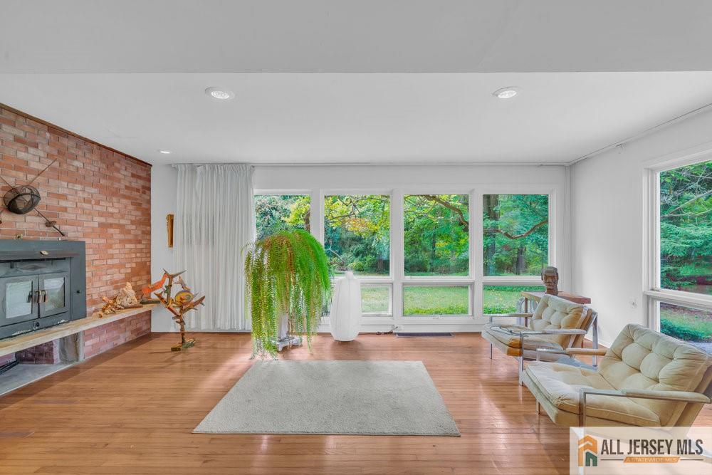 a living room with furniture and a floor to ceiling window