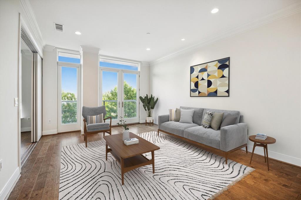 a living room with furniture and a painting on the wall