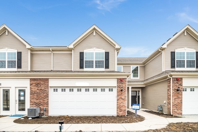 a view of a house with a yard and garage