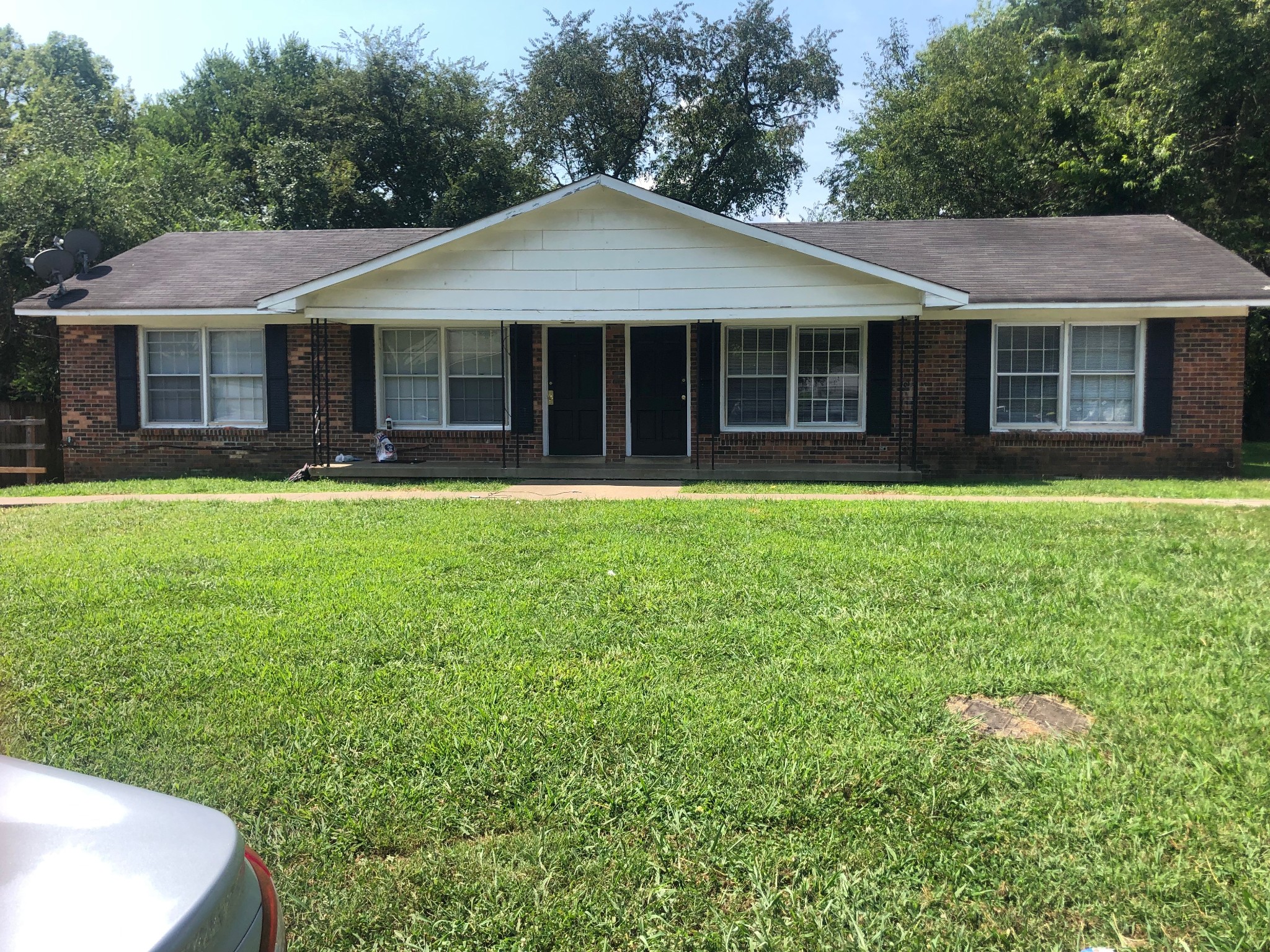 a front view of a house with a garden and porch