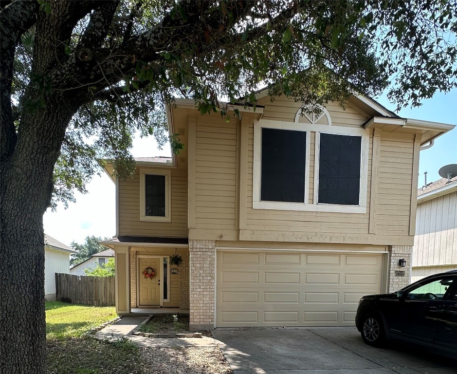 a view of a house with a large tree