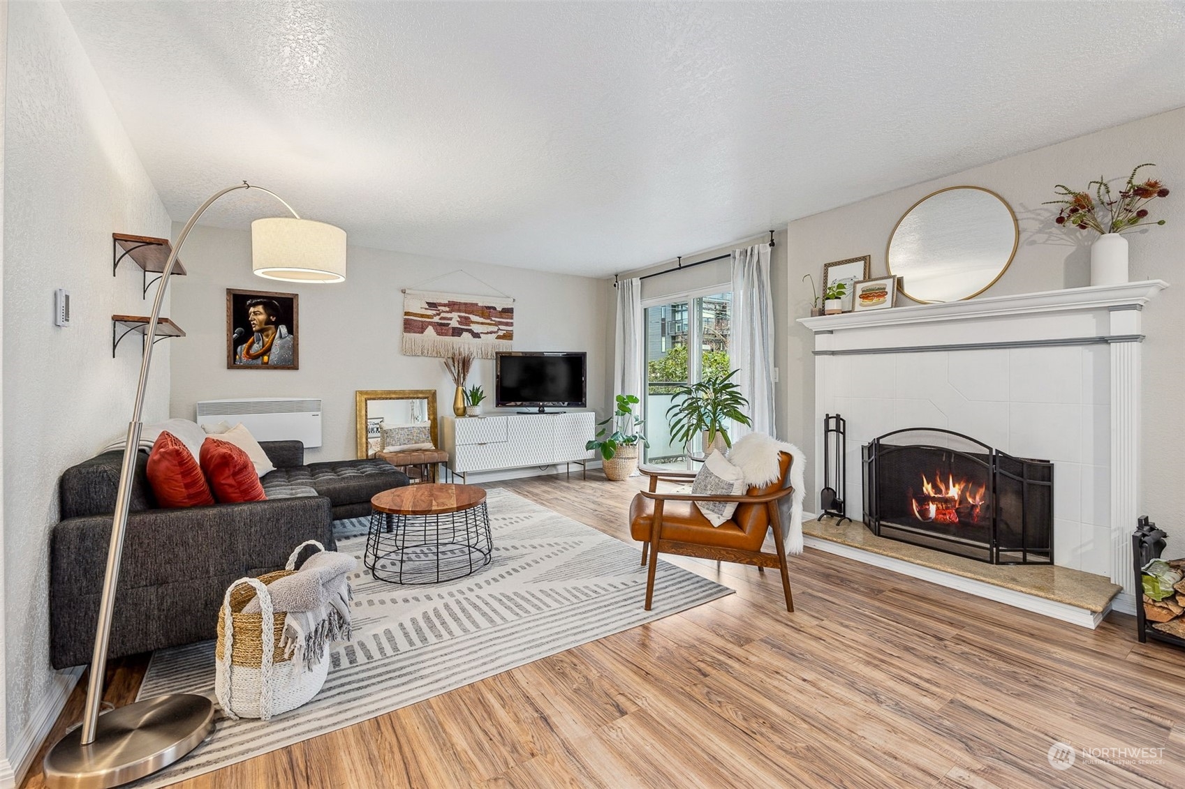 a living room with furniture a fireplace and a flat screen tv