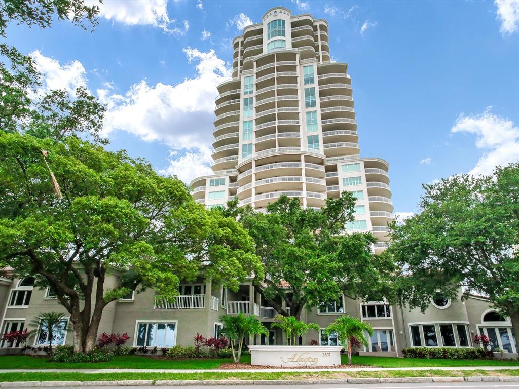 a front view of a building with trees