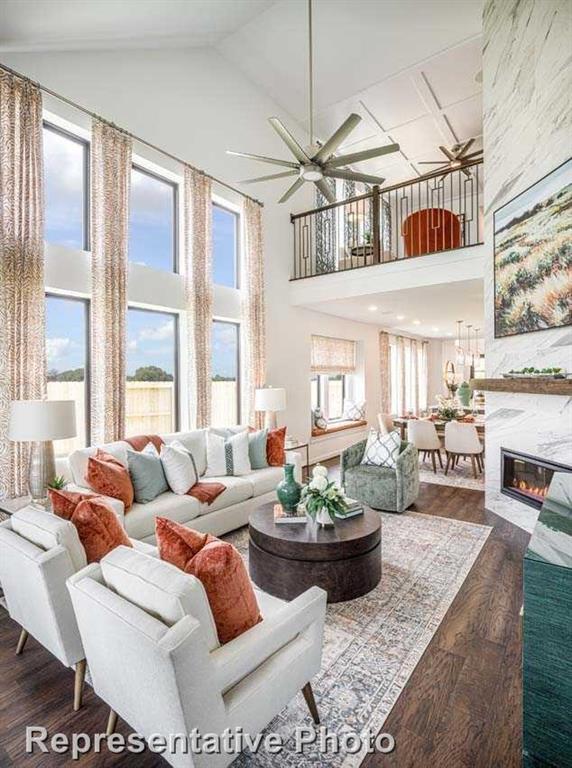 a living room with furniture fireplace and a large window