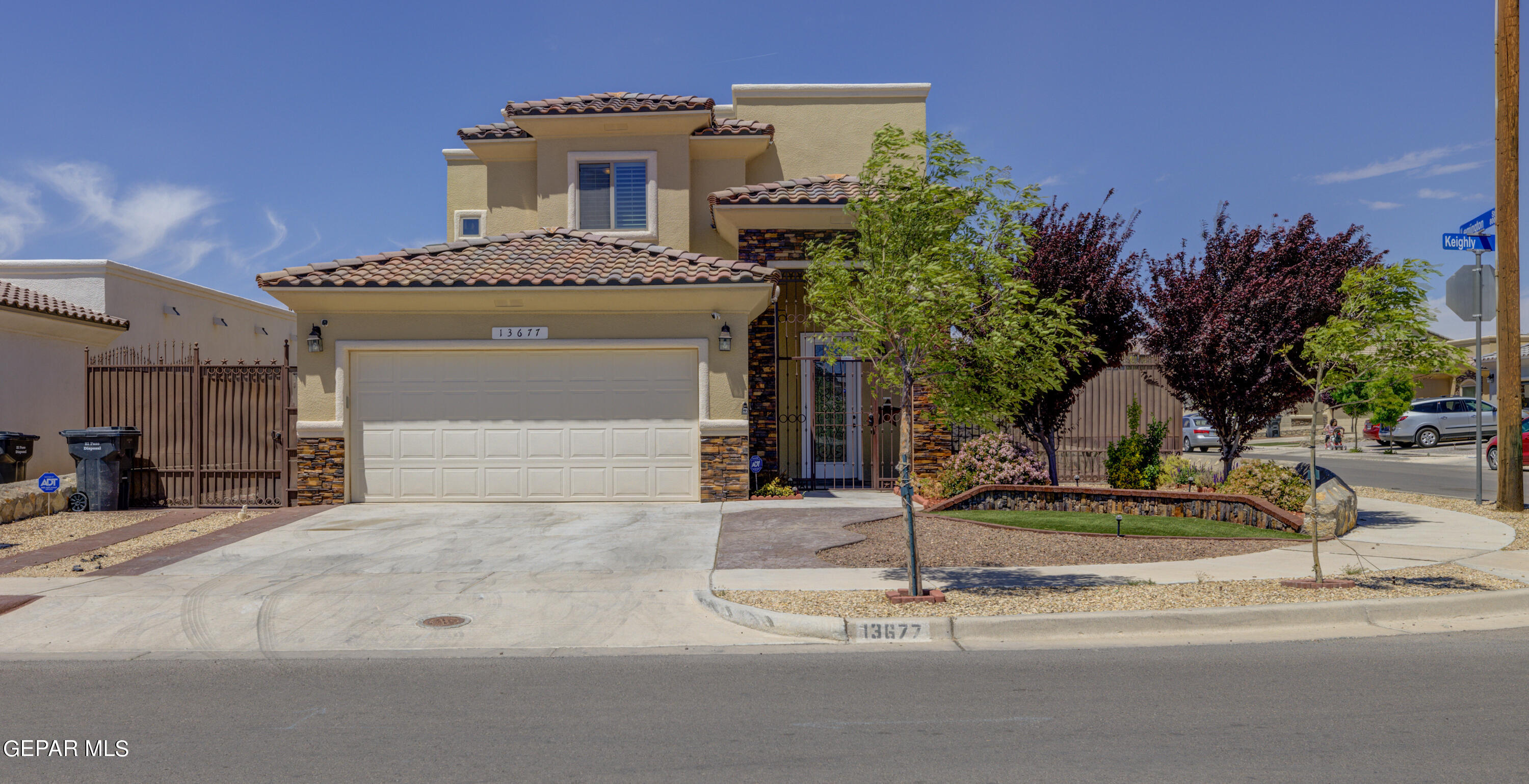 a view of a house with a yard and garage