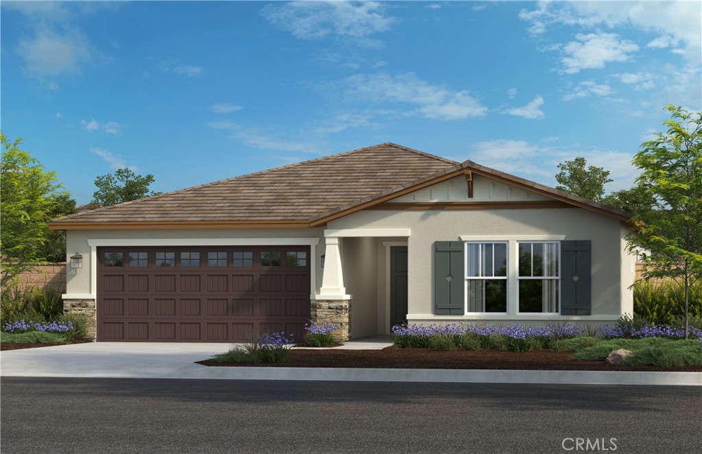 a front view of a house with a garden and garage