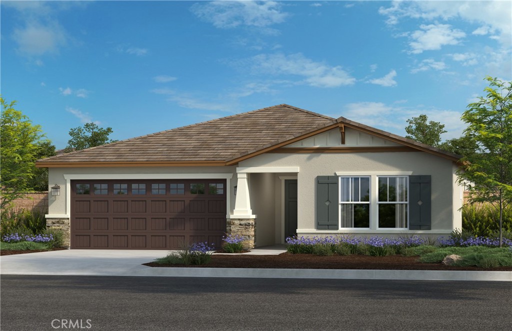 a front view of a house with a garden and garage