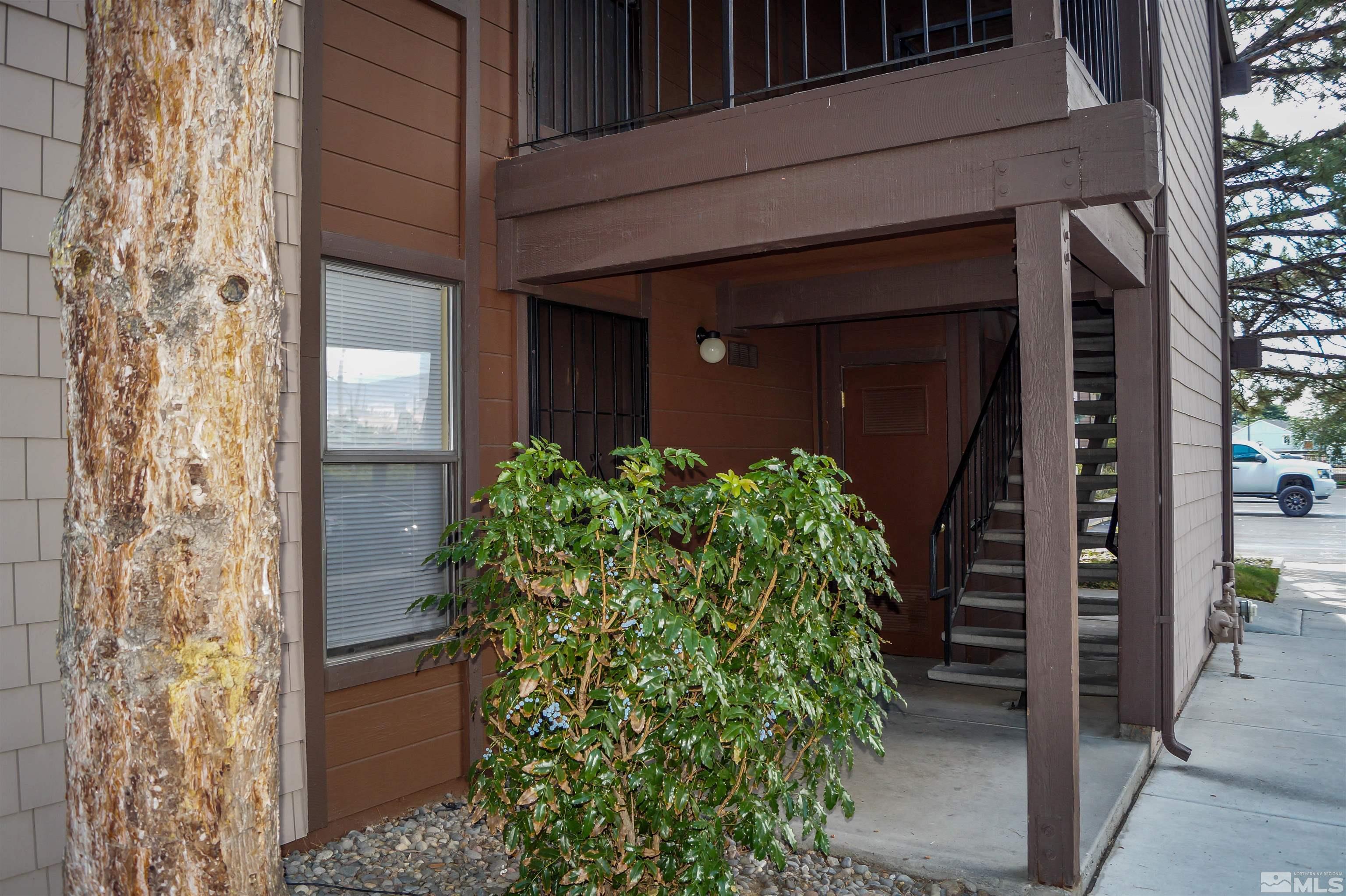 a couple of potted plants in front of door