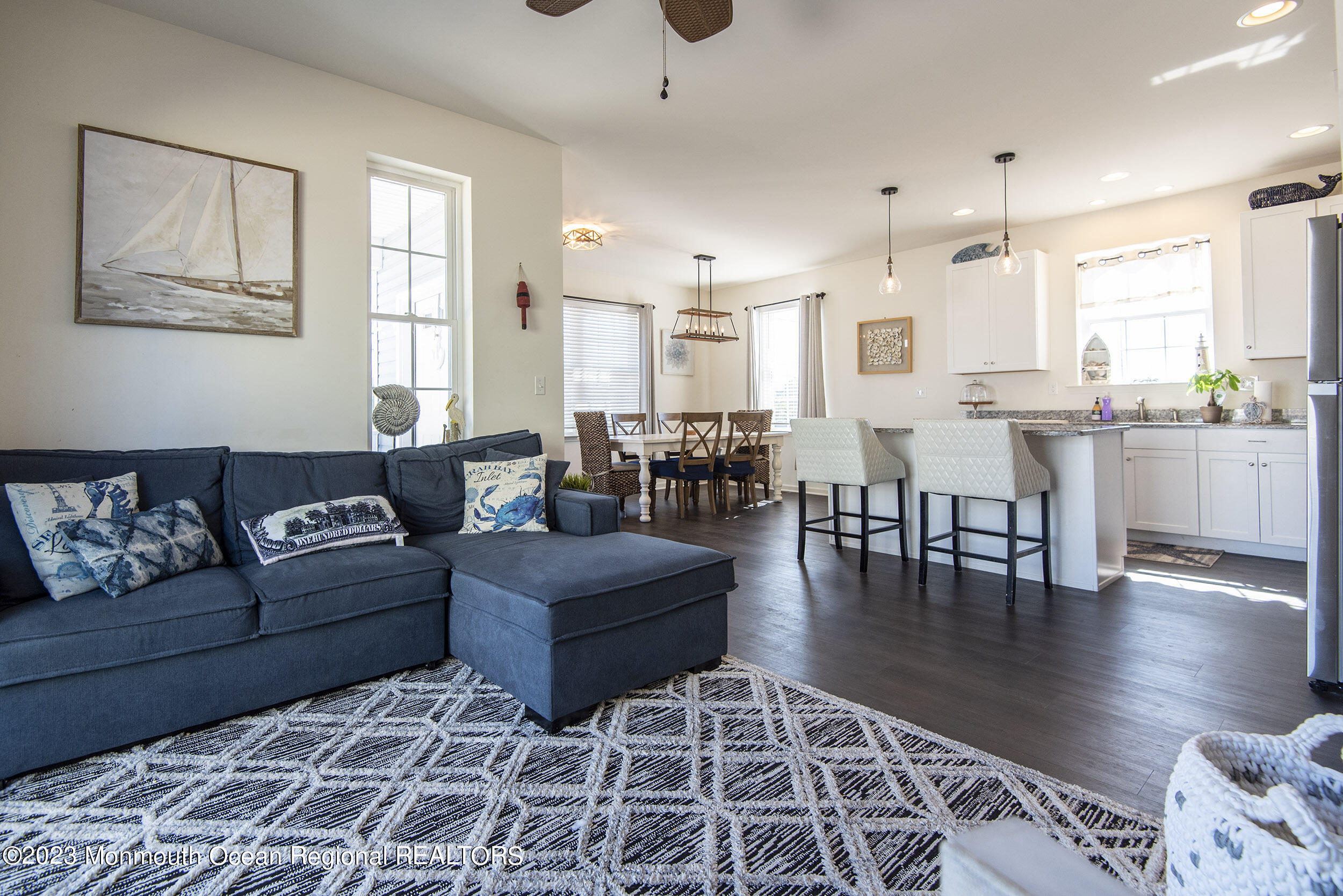 a living room with lots of furniture and wooden floor