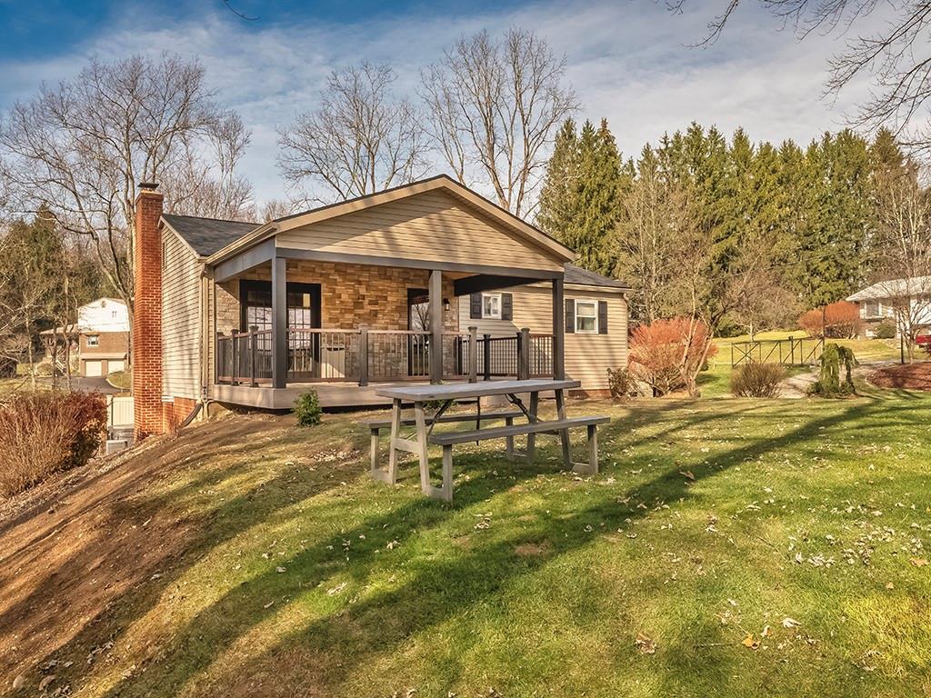 a backyard of a house with table and chairs