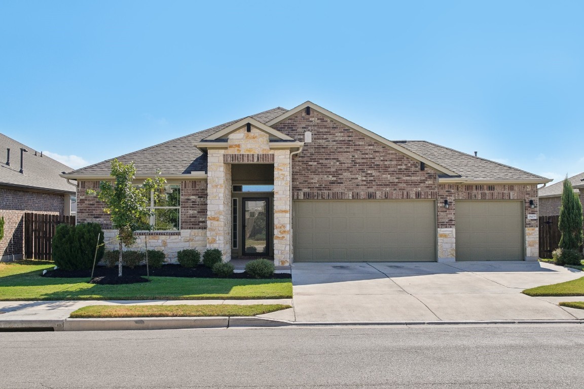 a front view of a house with a yard and garage