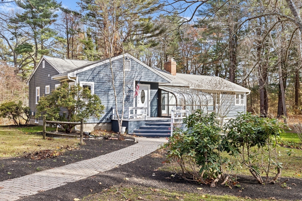 a front view of a house with a garden