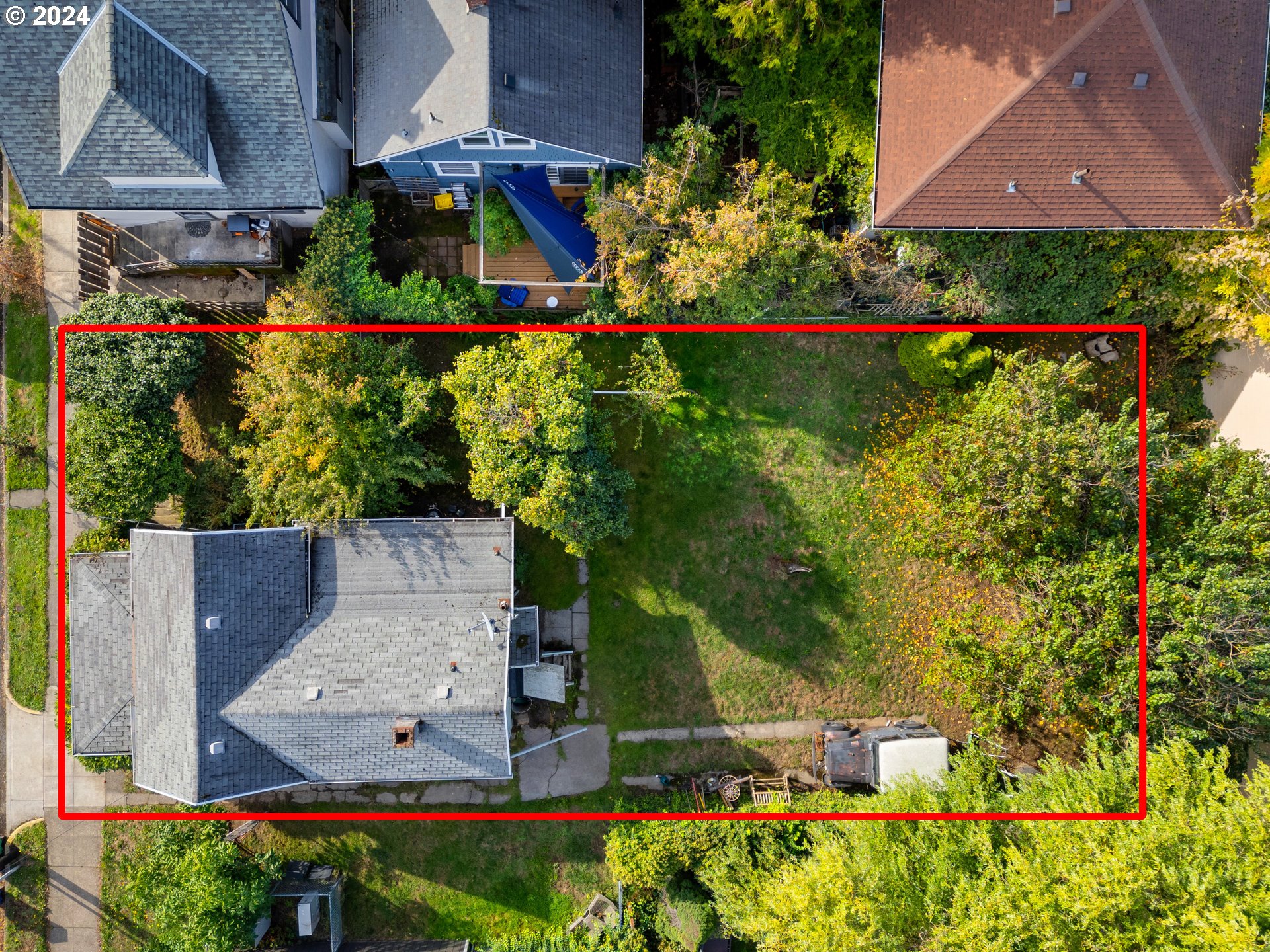 an aerial view of a house with a yard and garden