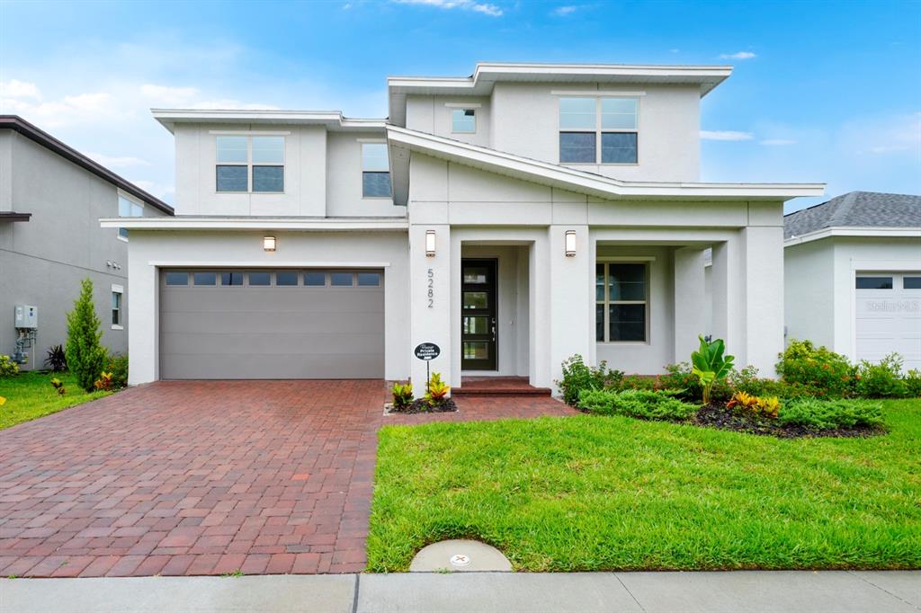 a front view of a house with a yard and garage