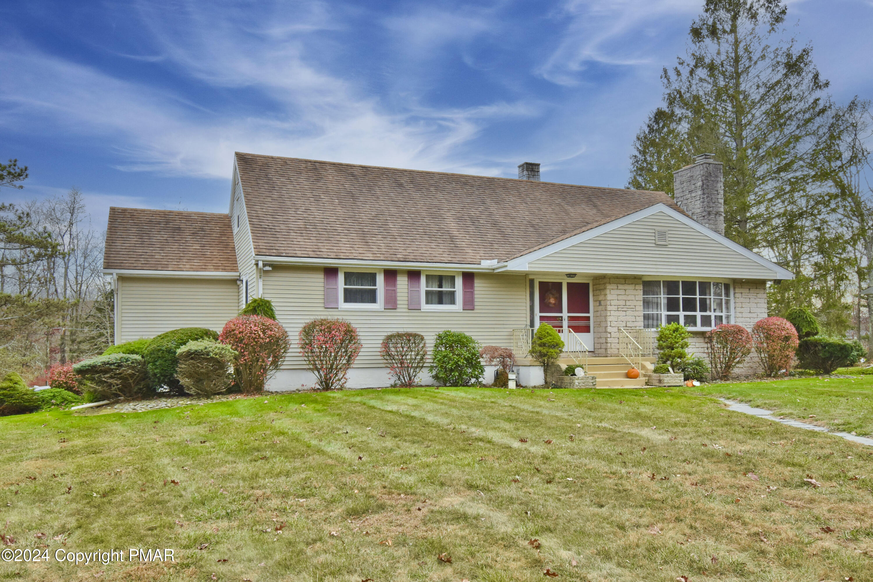 a front view of a house with garden