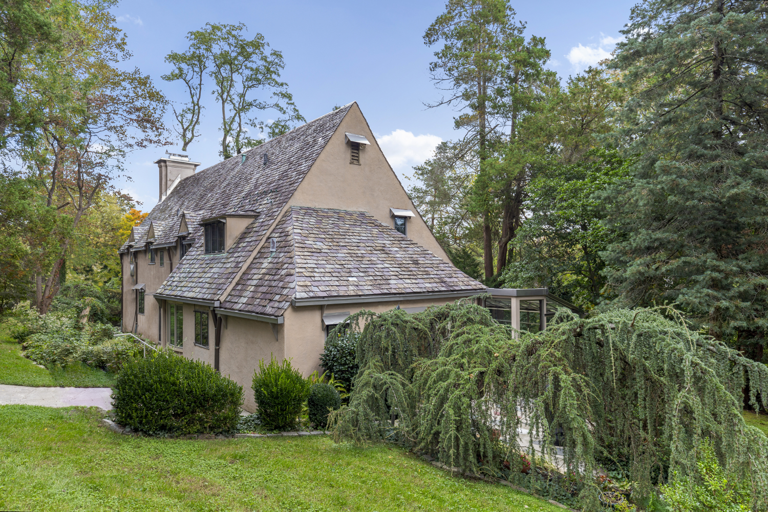 a aerial view of a house with swimming pool and garden