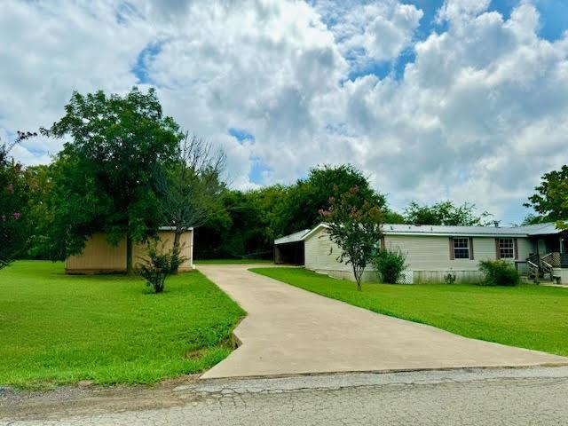 a view of house with a yard