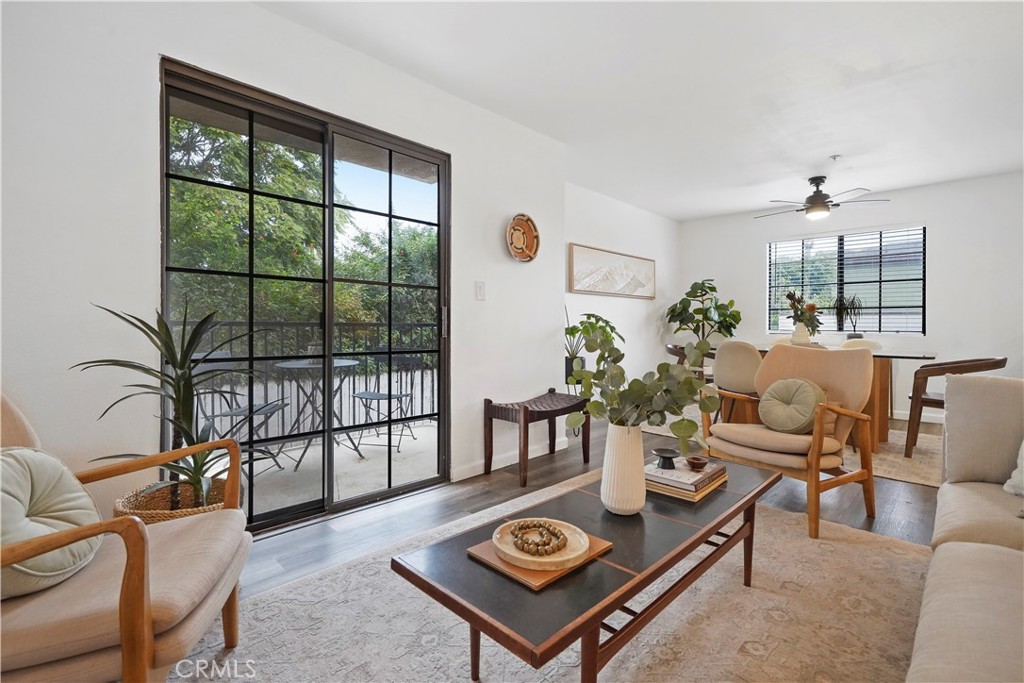 a living room with furniture a large window and a table