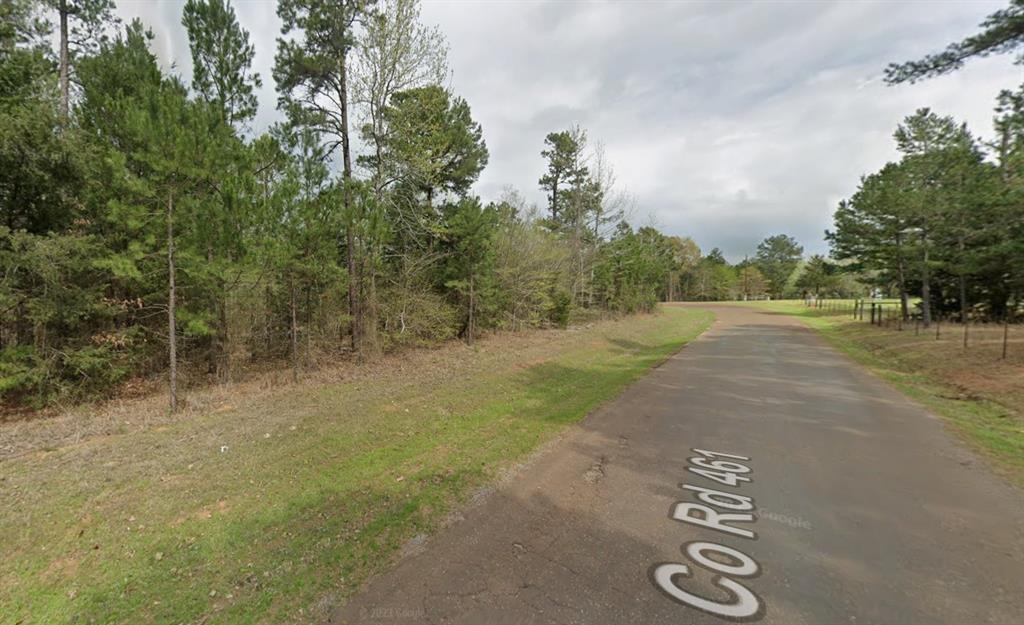 a view of a road with trees in the background