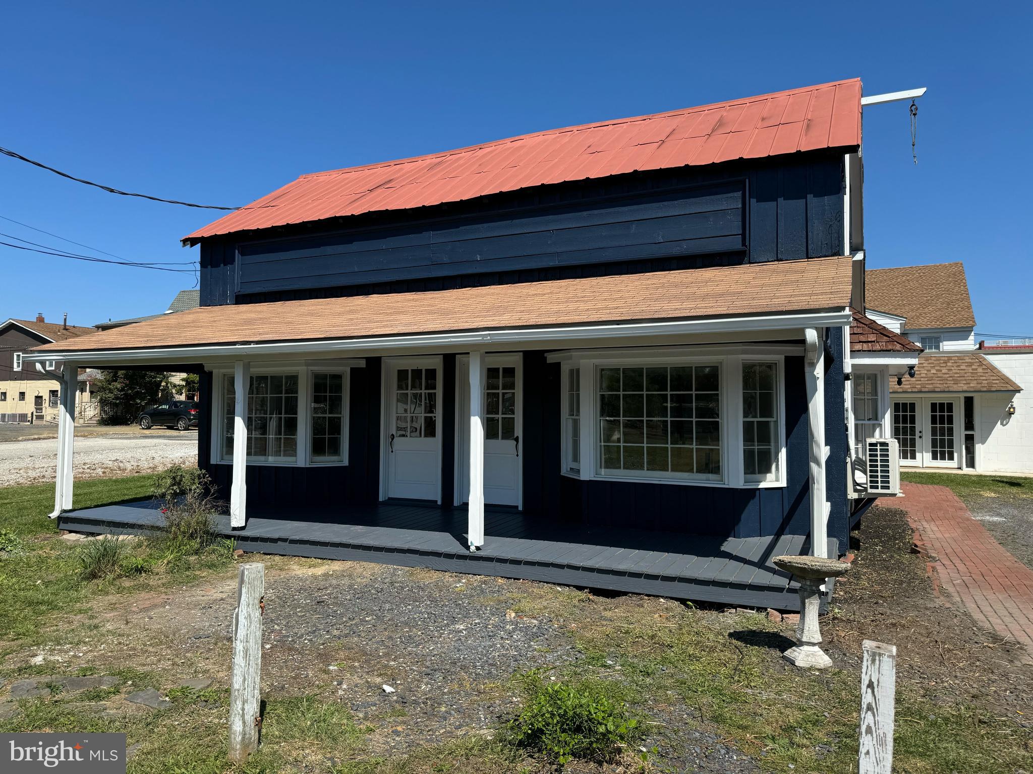 a view of house with chair and a porch