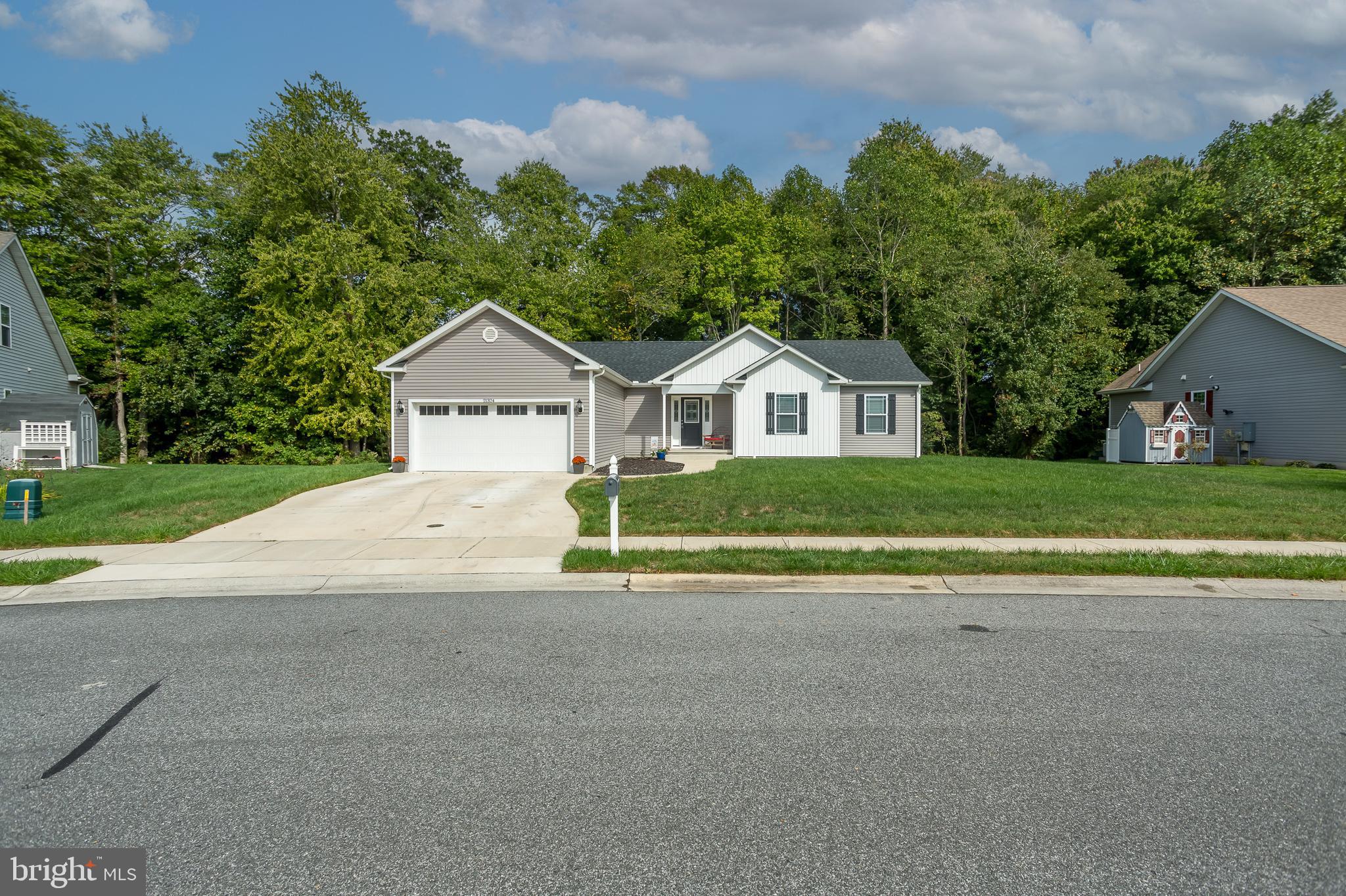 a house with a yard and a large parking space