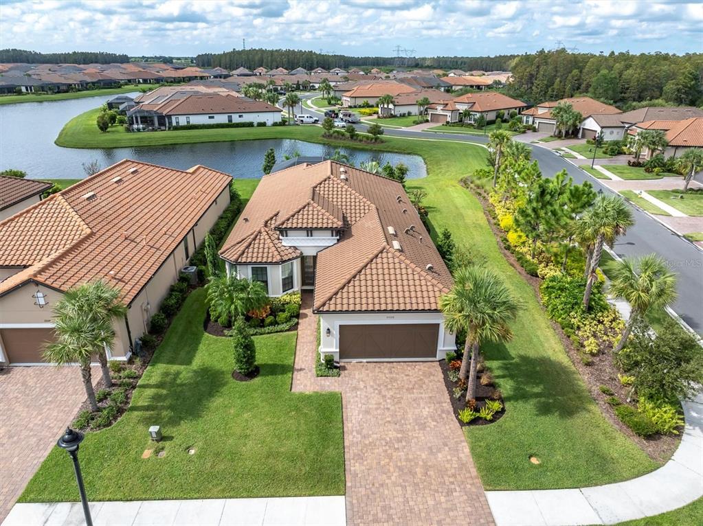 an aerial view of a house with swimming pool garden and outdoor seating