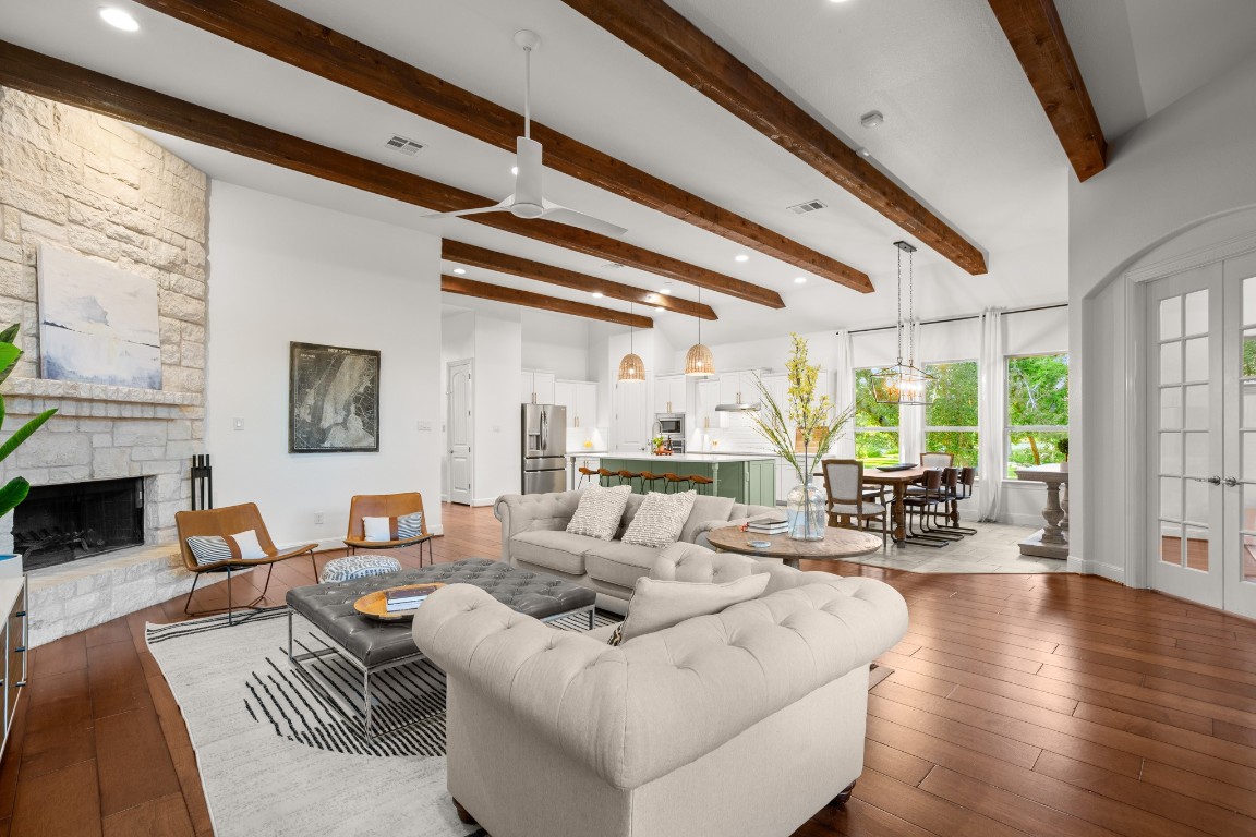 a living room with fireplace furniture and a large window