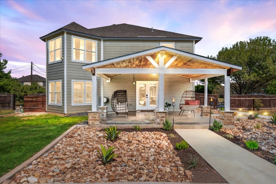 a view of a house with backyard and sitting area