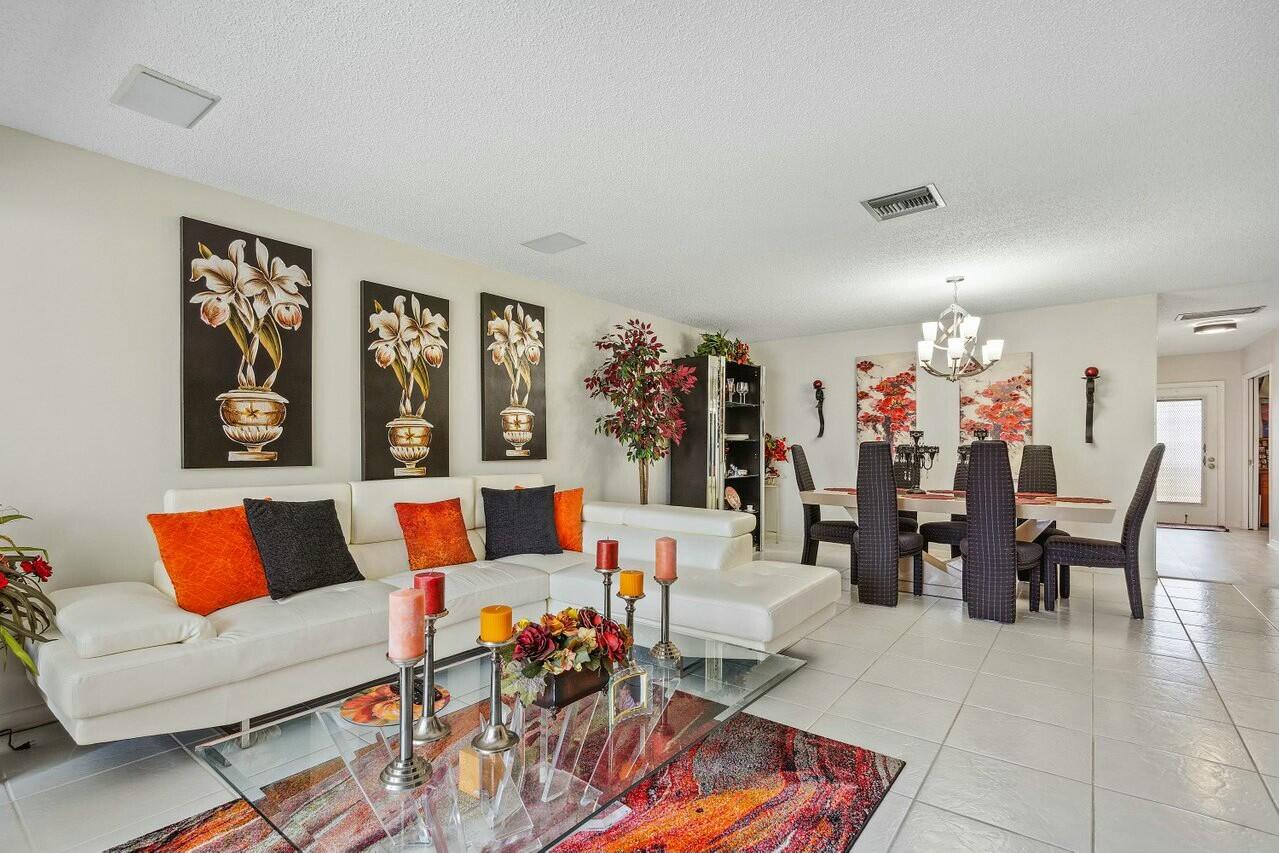 a living room with furniture and a dining table