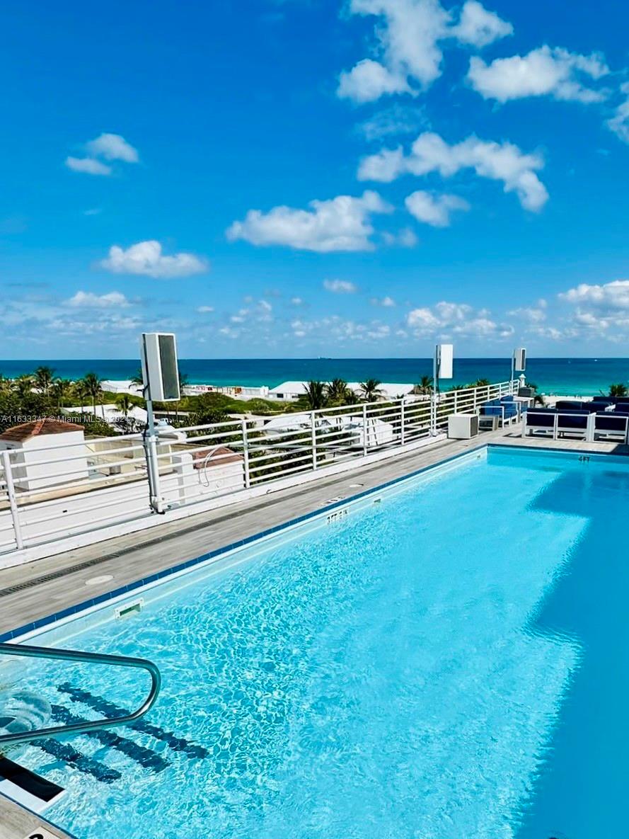 a view of a swimming pool with outdoor seating