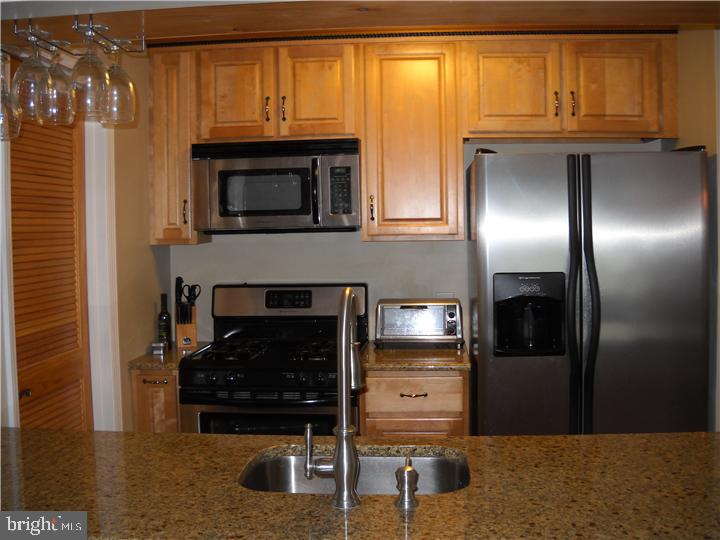 a kitchen with furniture and a fireplace