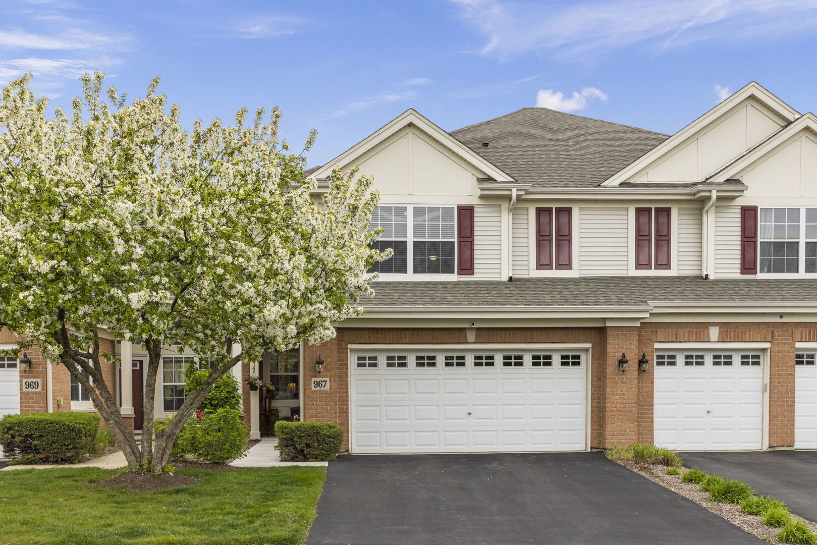 a front view of a house with a yard and garage