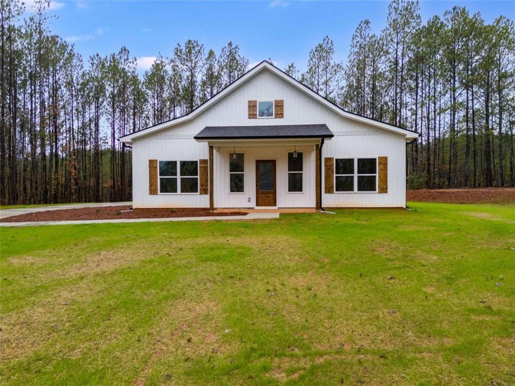 a front view of house with yard and green space