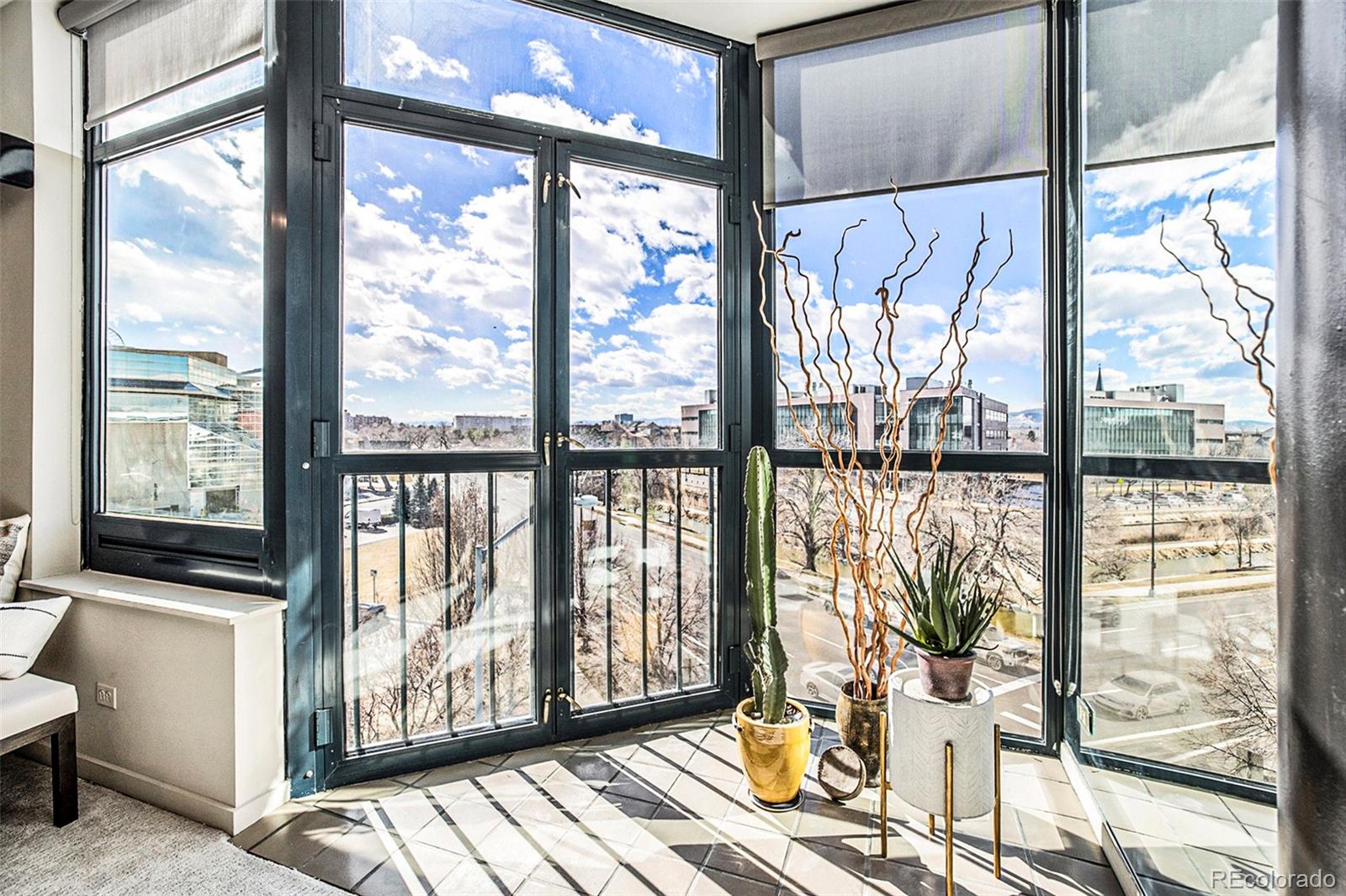 a view of a living room with furniture and floor to ceiling windows