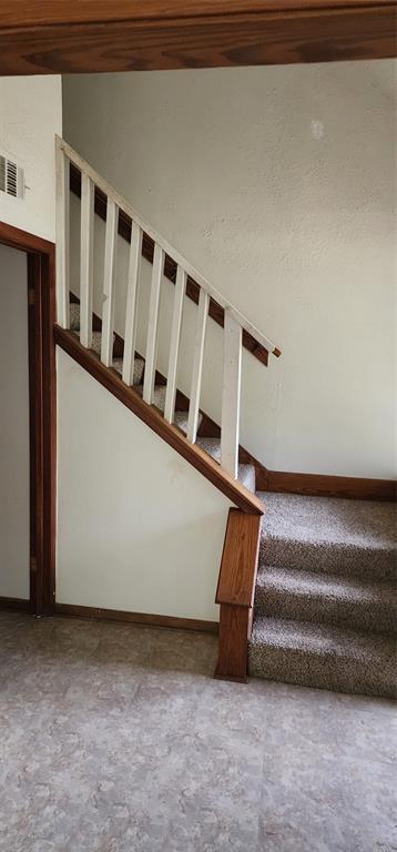 a view of staircase with lots of white walls