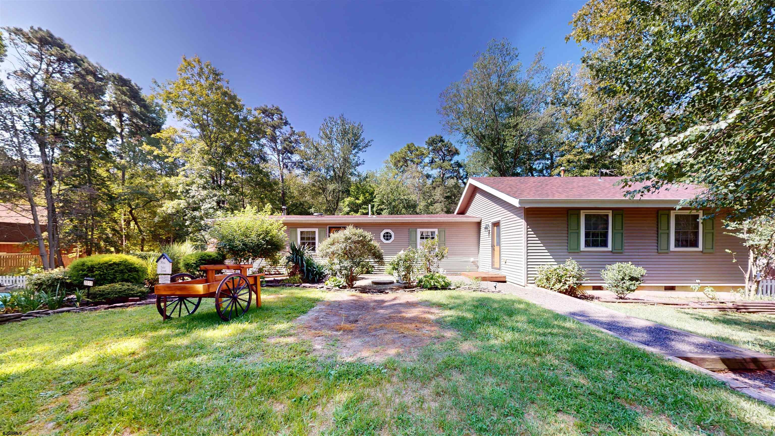 a view of a house with backyard porch and sitting area