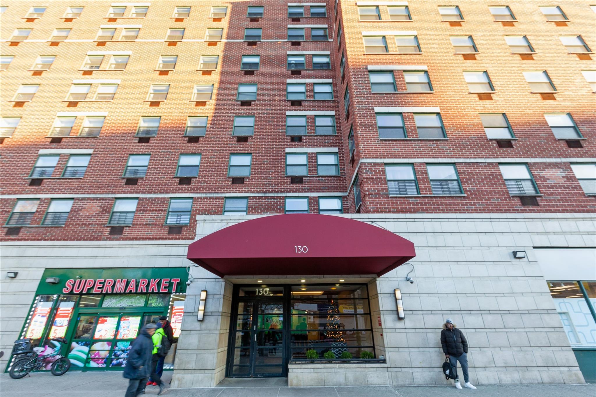 a man walking down a street next to a building