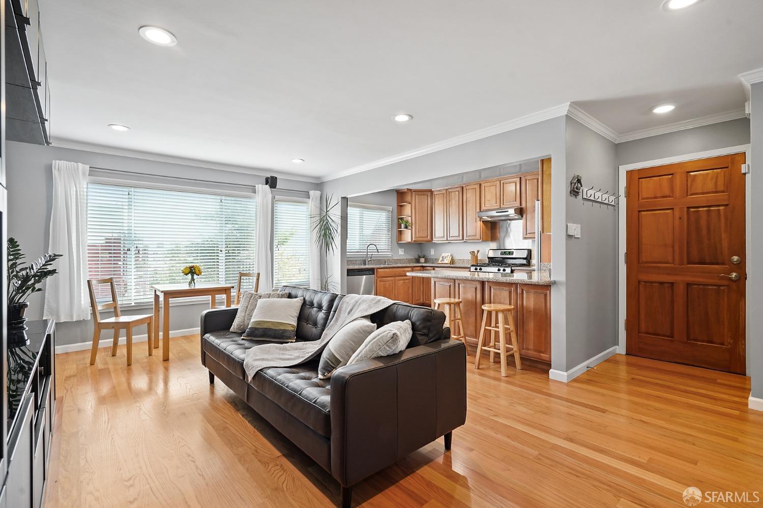 a living room with furniture and a wooden floor