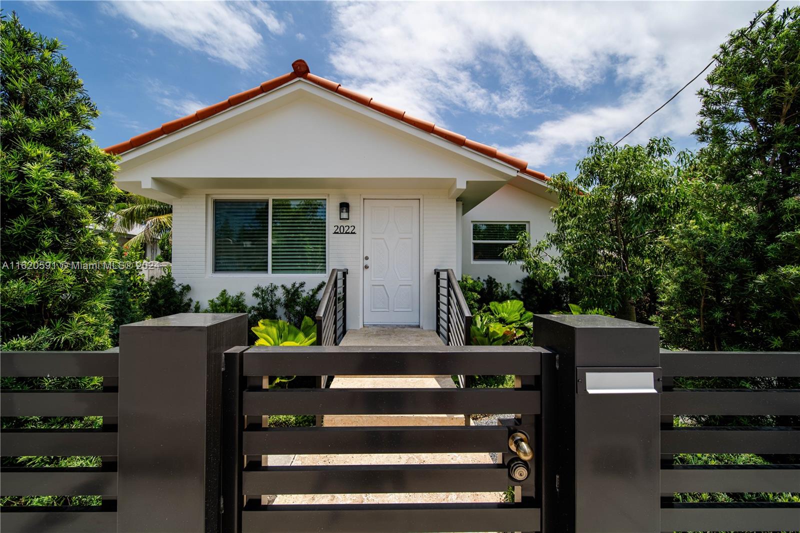 a front view of a house with garden