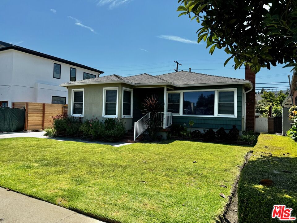 a view of a house with swimming pool and a yard