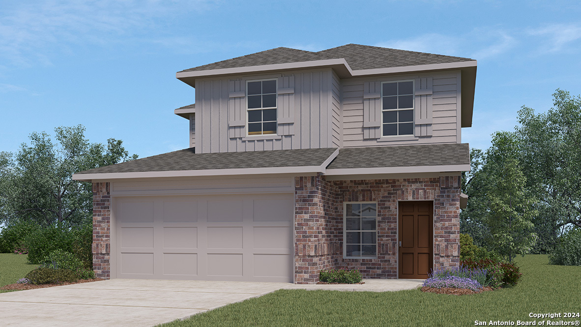 a front view of a house with a garden and garage