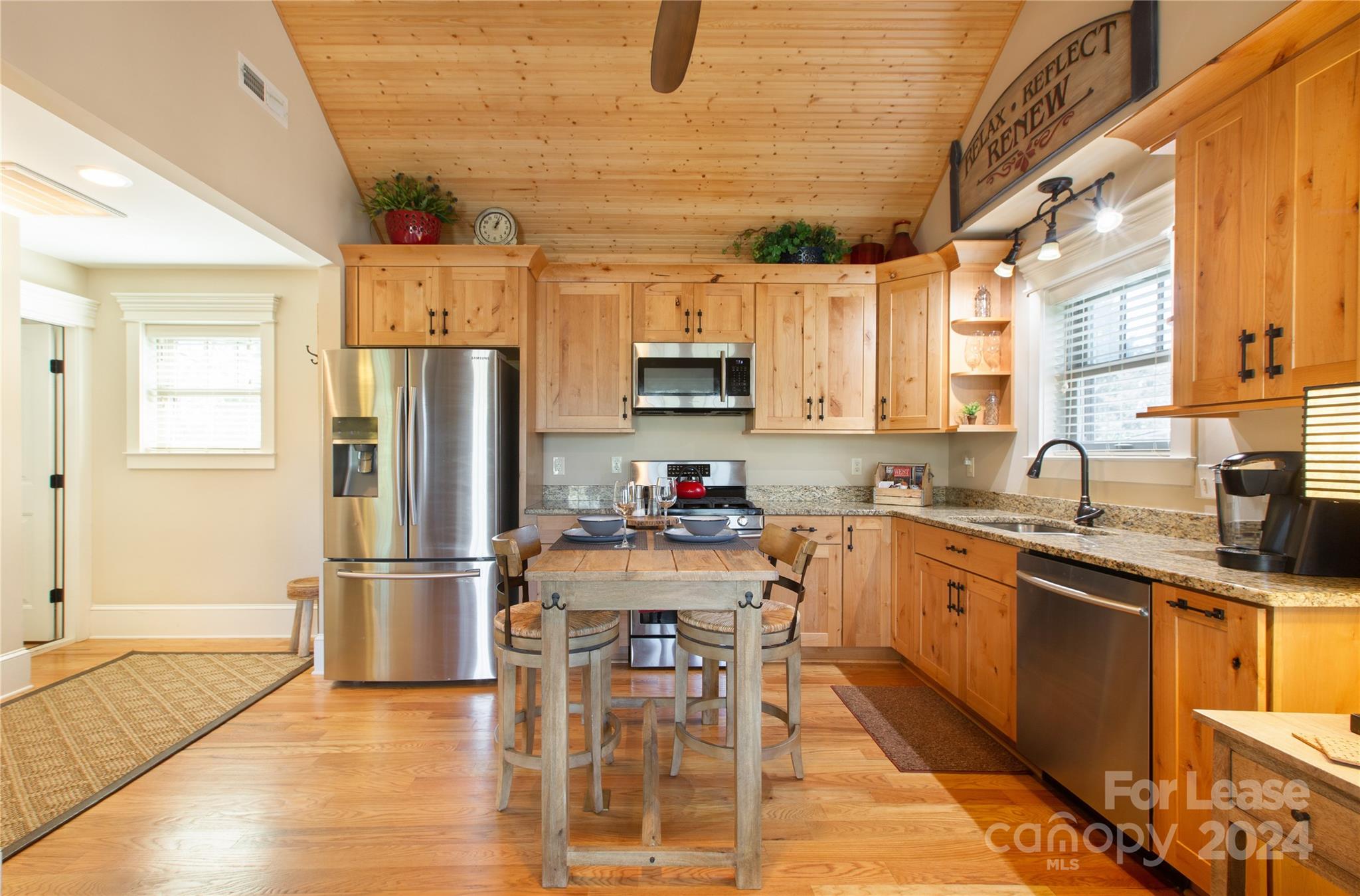 a kitchen with a refrigerator and a sink