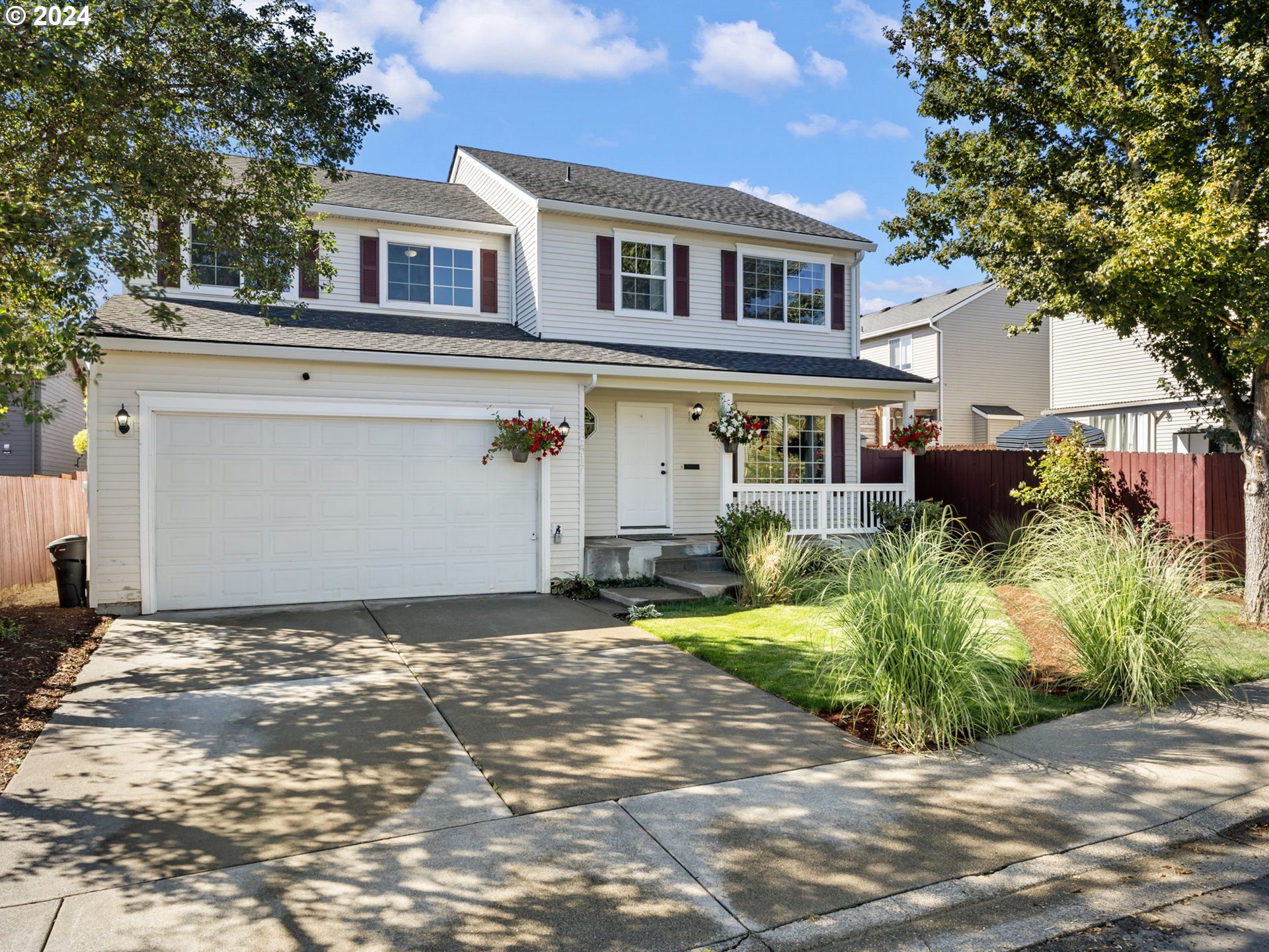 a front view of a house with a yard and a garage