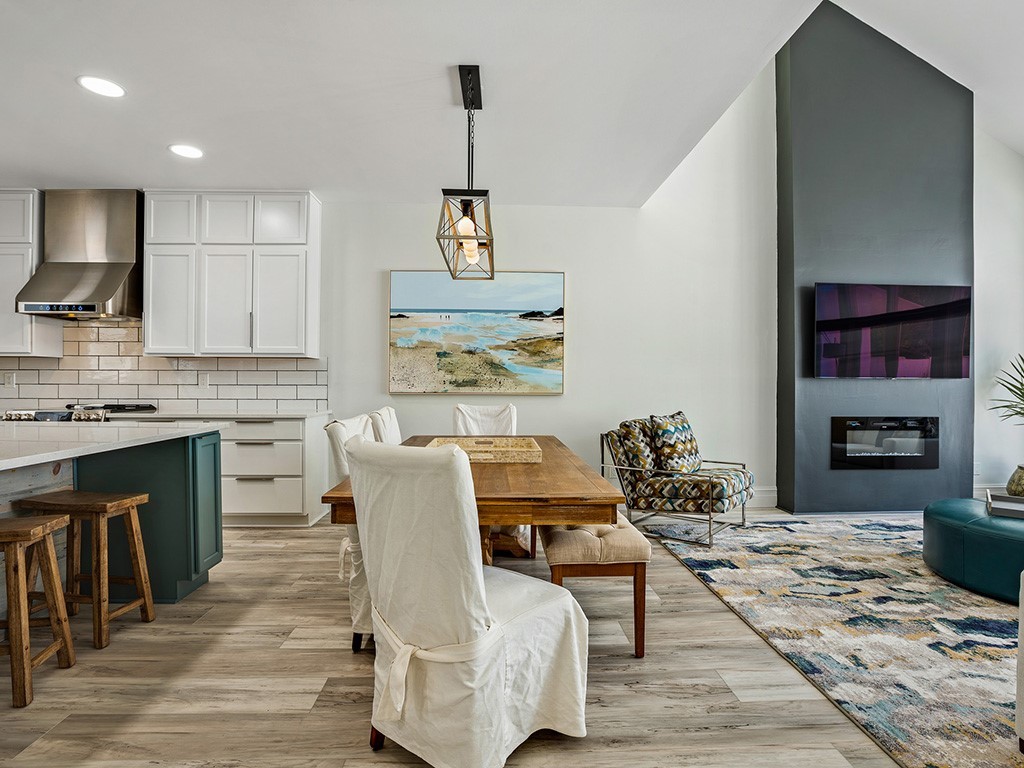 a living room with furniture a fireplace and a kitchen view